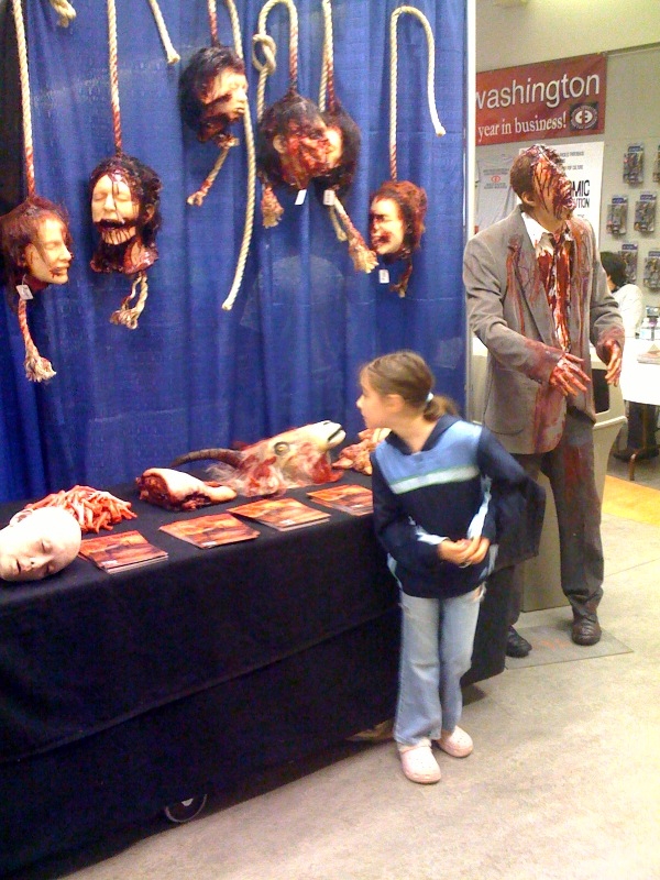 A little girl checks out the severed heads.